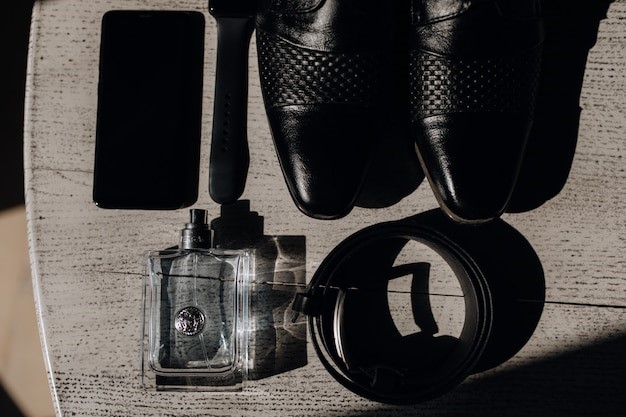 shoes, belt, perfume and telephone on the wooden surface, Picture